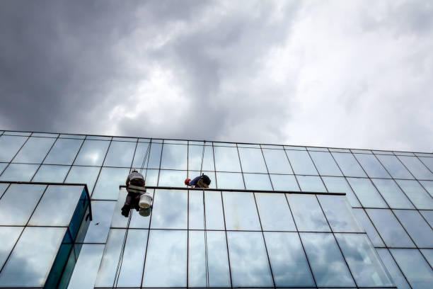istock Industrial climbers are applying silicone on joints between windows 962178156