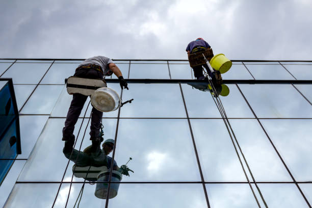 istock Industrial climbers are applying silicone on joints between windows 962178398
