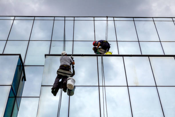 istock Industrial climbers are applying silicone on joints between windows 962178406