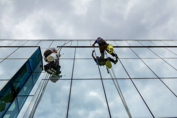 istock Industrial climbers are applying silicone on joints between windows 962178422