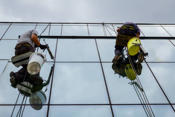 istock Industrial climbers are applying silicone on joints between windows 962178658