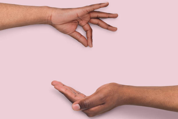 istock Black man picking up or giving something to other 962179164