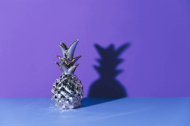 istock Tropical golden Pineapple on ultraviolet background 962179710