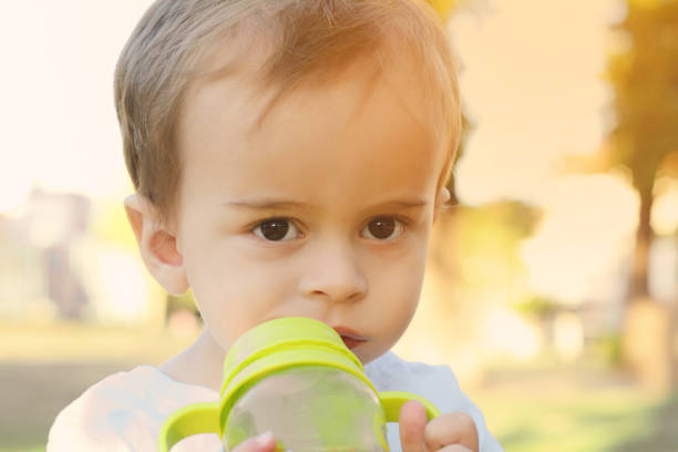 istock Cute Baby Boy Drinking Milk Bottle 962182530