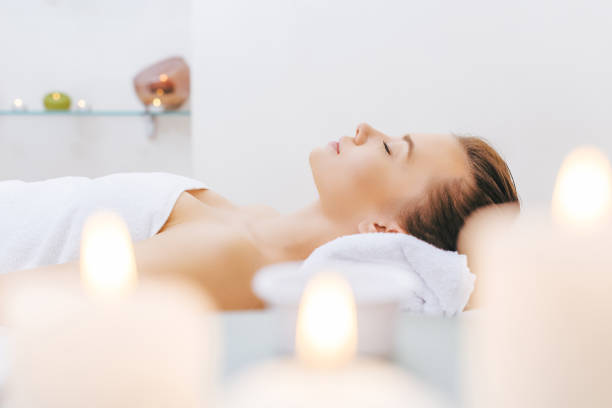 istock beautiful woman relaxing on massage table at spa salon 962186484