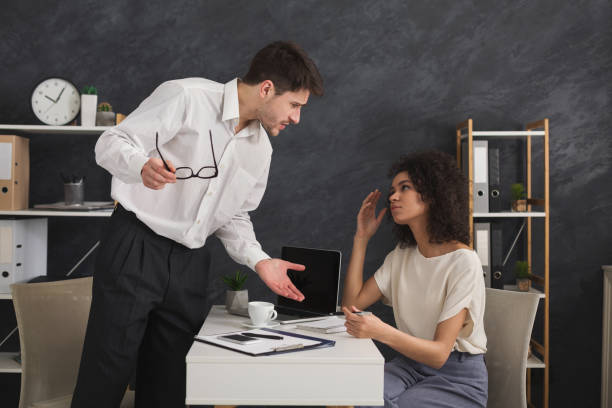 istock Couple of young colleagues arguing at office 962187150