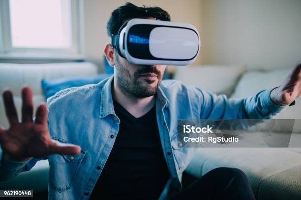 Serious Man Wearing Virtual Reality Glasses Stock Photo - Download Image Now - Eyeglasses, Three Dimensional, Adult