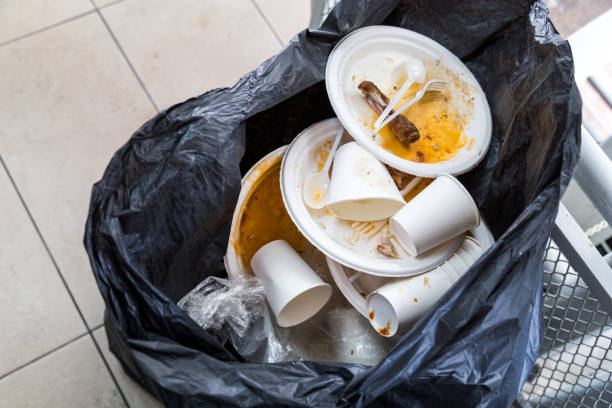 istock Environment unfriendly styrofoam plates and cups in plastic garbage bag 962192028