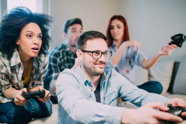 istock Man wearing eyeglasses playing video games with friends 962192062