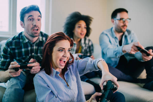 istock Ecstatic redhead woman playing video games with friends from home 962192118