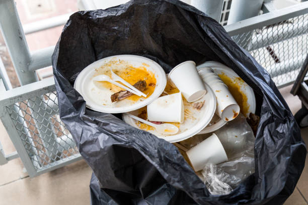 istock Environment unfriendly styrofoam plates and cups in plastic garbage bag 962192132