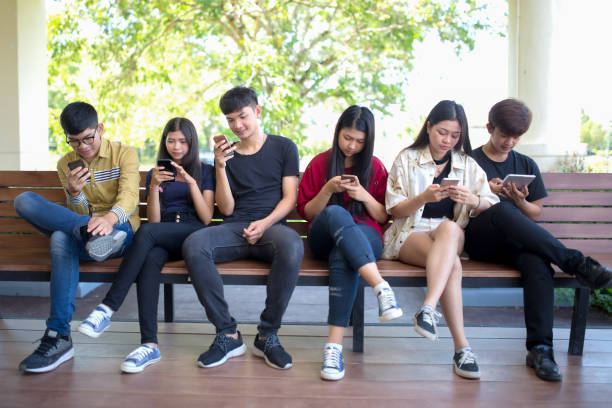 istock Group adult hipsters friends sitting sofa using hands modern smartphone tablet, Business startup friendship teamwork concept, People working together project 962192156