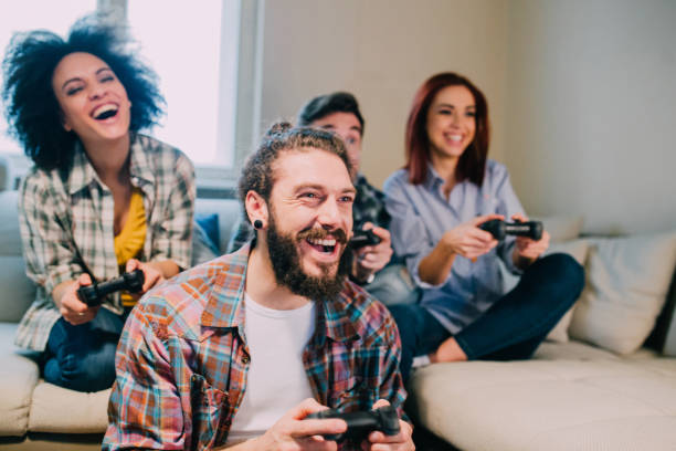 istock Bearded young man playing video games with friends 962192302