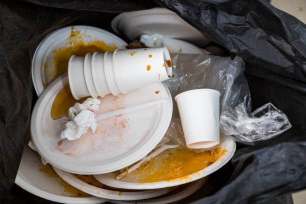 istock Environment unfriendly styrofoam plates and cups in plastic garbage bag 962192622