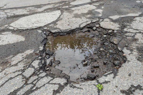 istock Large pothole filled with water in Montreal 962197232