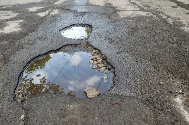 istock Large potholes filled with water in Montreal 962197490