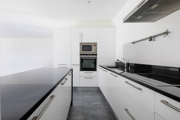Detail of white modern kitchen with latest generation appliances. Nobody inside