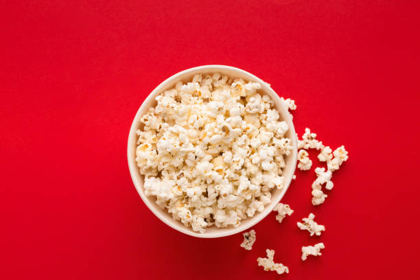 istock Bucket of popcorn on red background, top view 962198010
