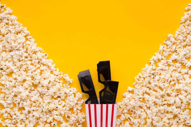 istock 3D glasses and popcorn on yellow background 962198442