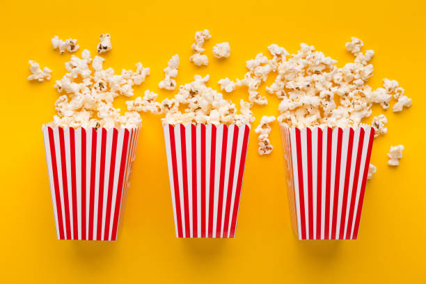 istock Buckets of popcorn on yellow background, top view 962198560