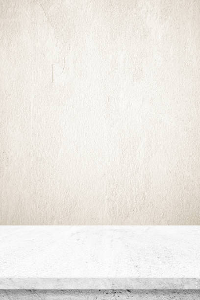 istock Empty white cement table over brown cement wall background, banner, table top, shelf, counter design for product display montage 962198832