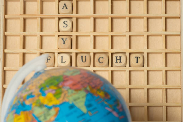 istock A globe, wooden letters and words asylum and flight 962199142