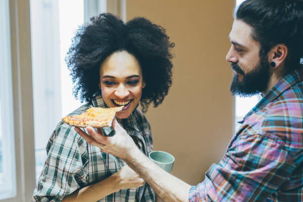 istock Woman taking a bite of pizza 962199326