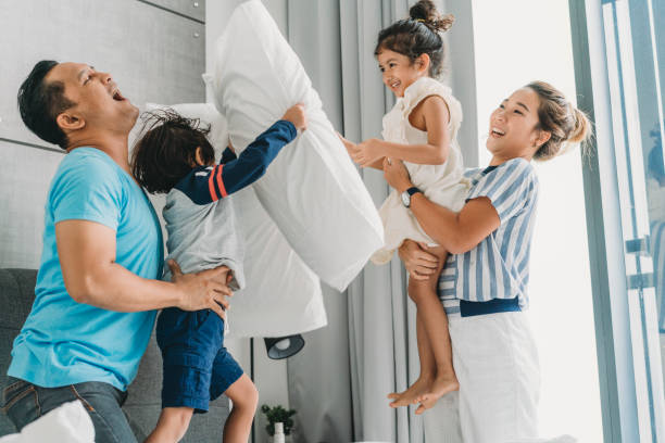 istock Happy family on the bed together 962203392