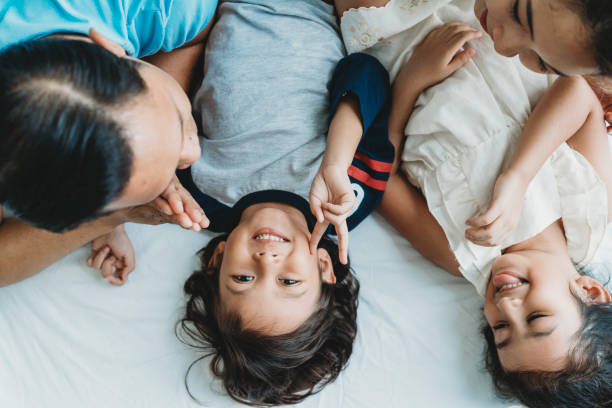 istock Happy family on the bed together 962203416