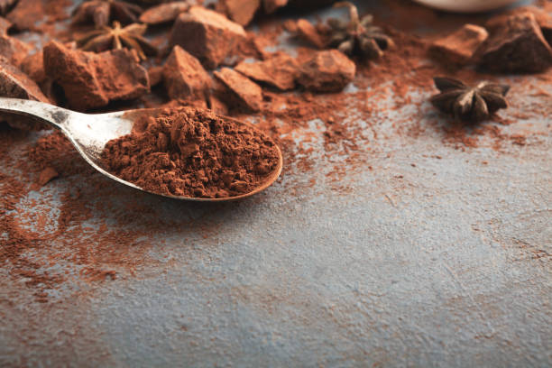 istock Crushed chocolate pieces and cocoa on gray background 962203606