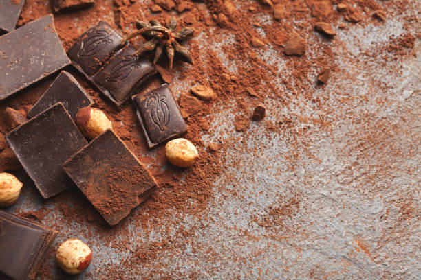 istock Crushed chocolate bar pieces and cocoa on gray background 962203854