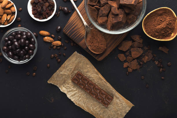 istock Top view on chocolate and nuts on black background 962204466