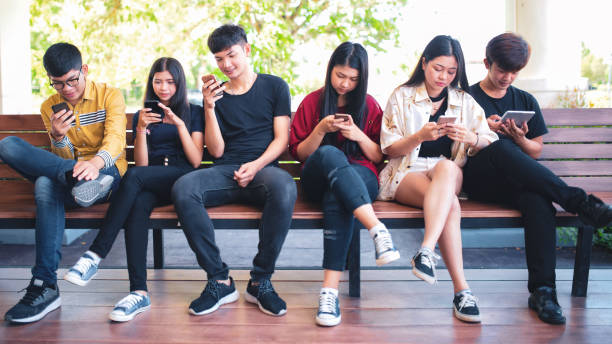 istock Group adult hipsters friends sitting sofa using hands modern smartphone tablet, Business startup friendship teamwork concept, People working together project 962211380