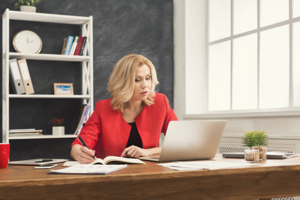 istock Businesswoman working with documents at office desktop 962212202