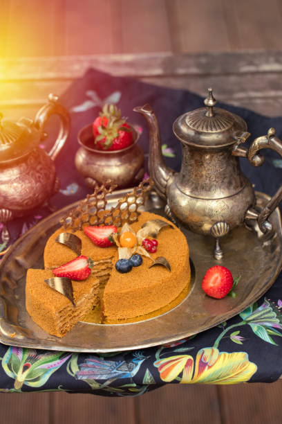 istock Honey cake, decorated with fresh berries. Old tea set 1 962214870