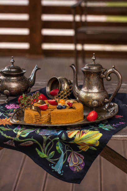 istock Honey cake, decorated with fresh berries. Old tea set 1 962214880