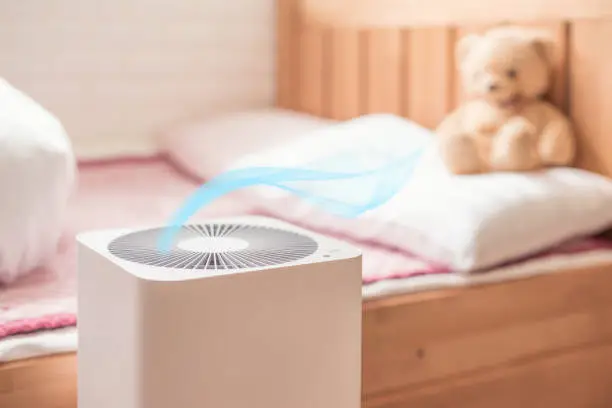 air purifier in bed room. air cleaner removing fine dust in house.