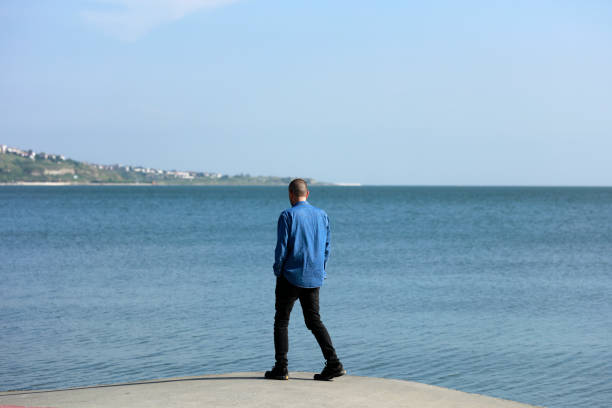 Young man looking at the Ocean