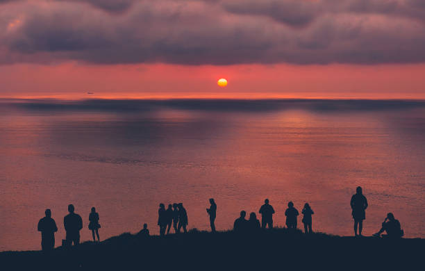 istock people watching the sunset on the sea 962216564
