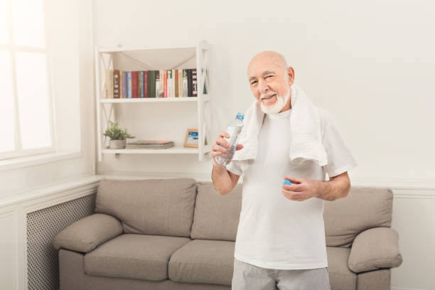 istock Thirsty senior man drinking water from bottle 962219286