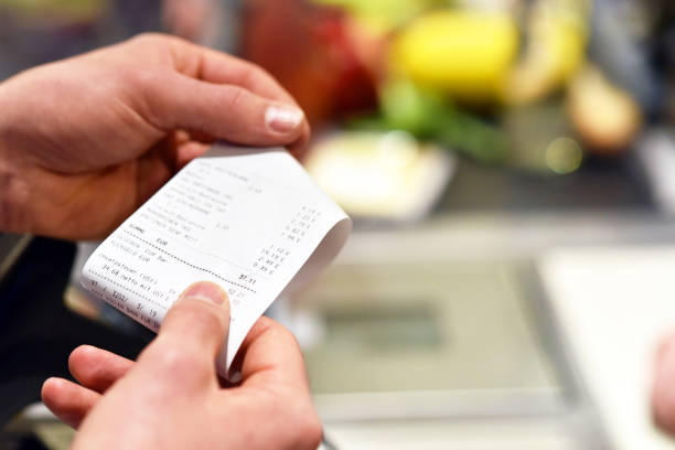 receipt after payment in the supermarket - supermarket imagens e fotografias de stock