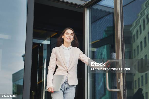 Confident Young Businesswoman Talking On Mobile Stock Photo - Download Image Now - Leaving, Walking, Office