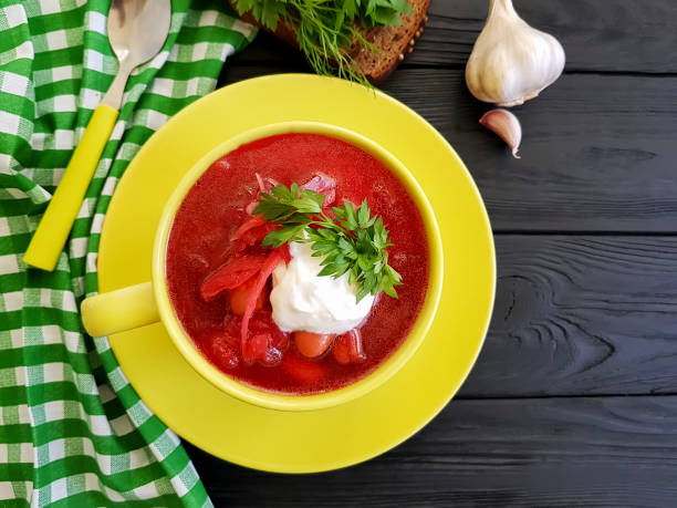 istock red soup, bread, garlic on a black wooden background 962224574