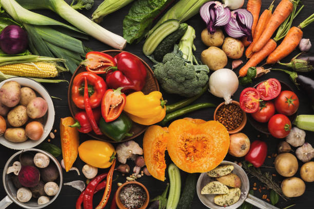 istock Heap of fresh vegetables on wooden background with copy space 962225324