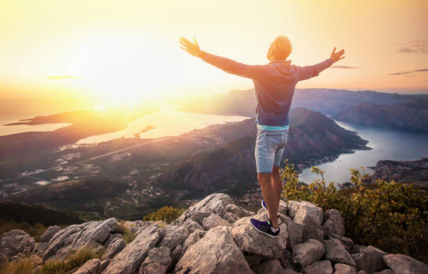 istock Happy man in the mountains looking at the sunset 962226488
