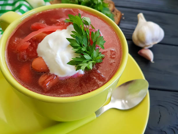 istock red soup, bread, garlic on a black wooden background 962229802