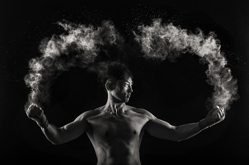 black and white photo of asian male boxing portrait with powder