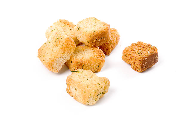 Small pile of herb croutons on a white background stock photo