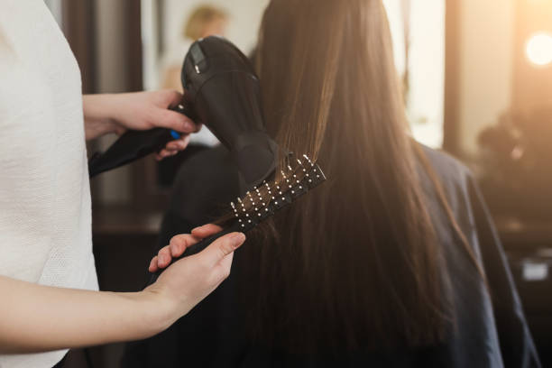 estetista asciuga i capelli della donna - brilliant cut foto e immagini stock