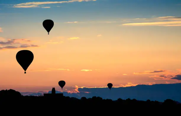 Photo of Hot air balloons on sunset. Beautiful nature background.